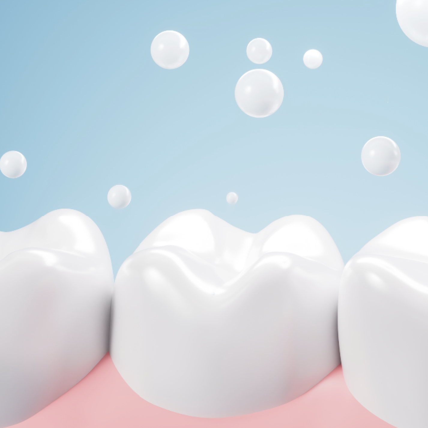 Close-up of clean, shiny teeth with bubbles on a blue background.